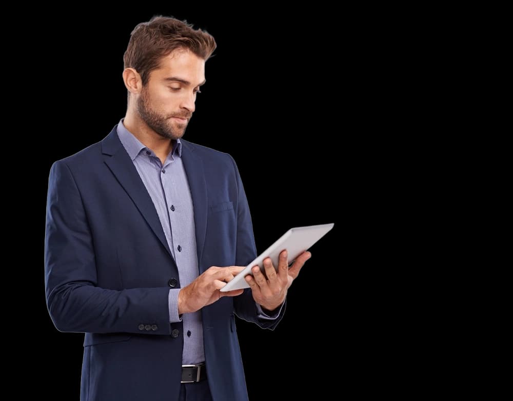 man in a suit looking at a tablet