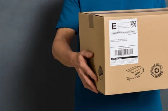 hands holding a box with a shipping label on it