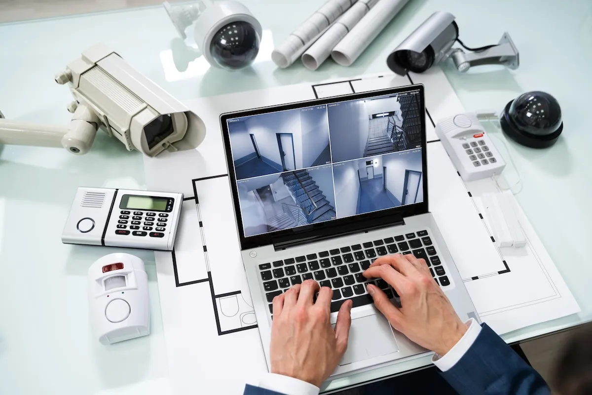 man using warehouse security systems equipment and computer on desk