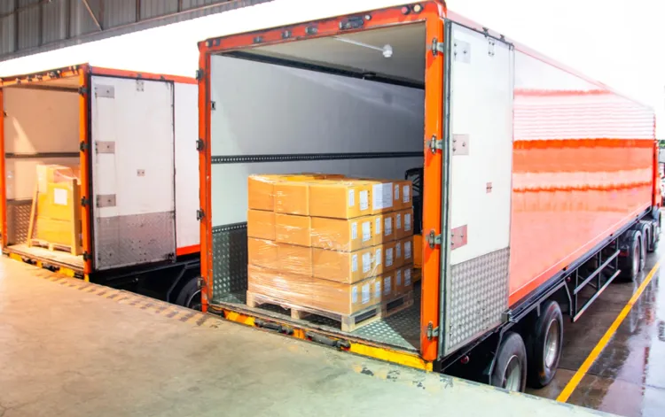 Loading dock with delivery truck and stacked boxes for efficient warehouse shipping operations