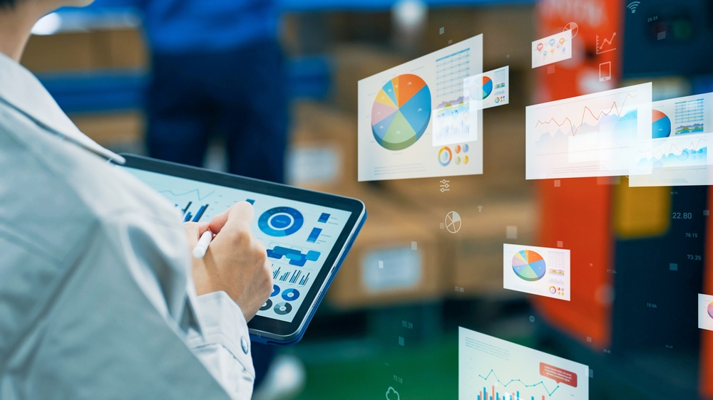 manager calculating how to reduce warehouse costs with tablet and charts