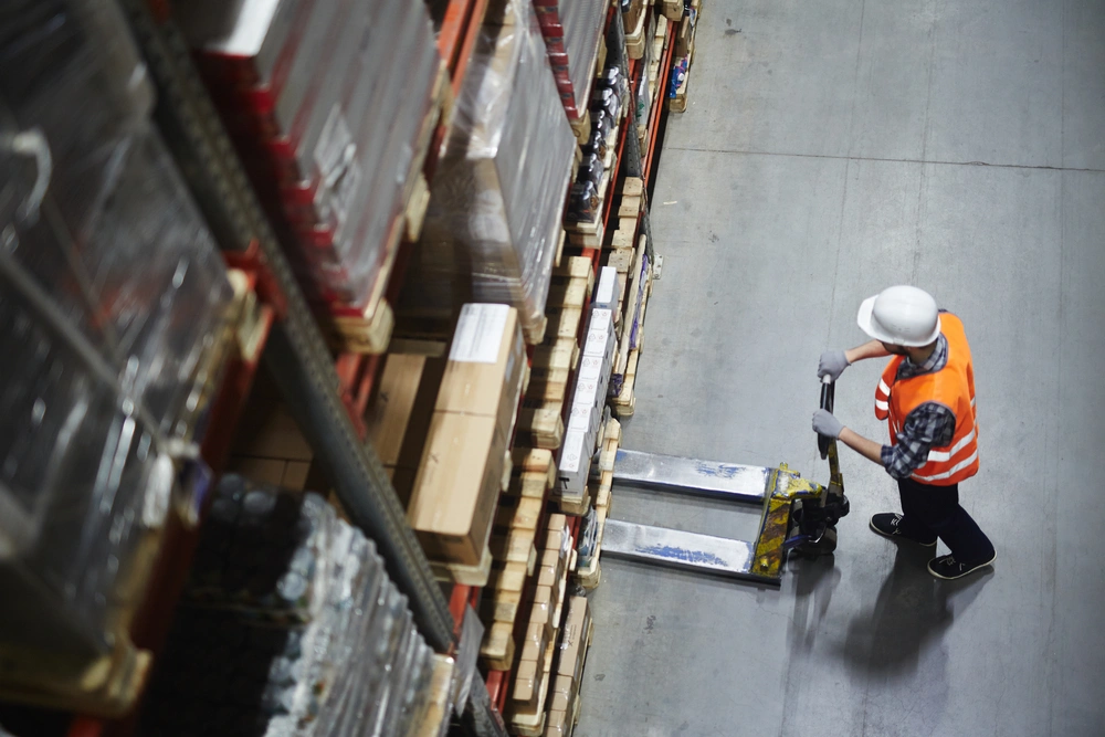 warehouse worker picking up a pallet