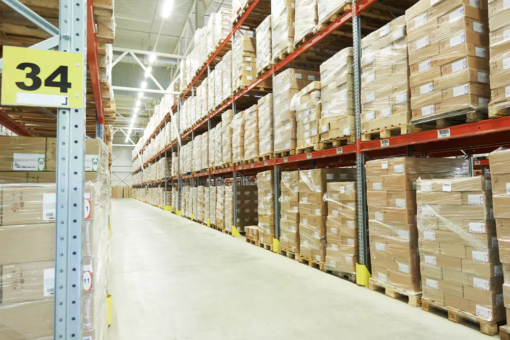 warehouse aisle with shelving full of boxes