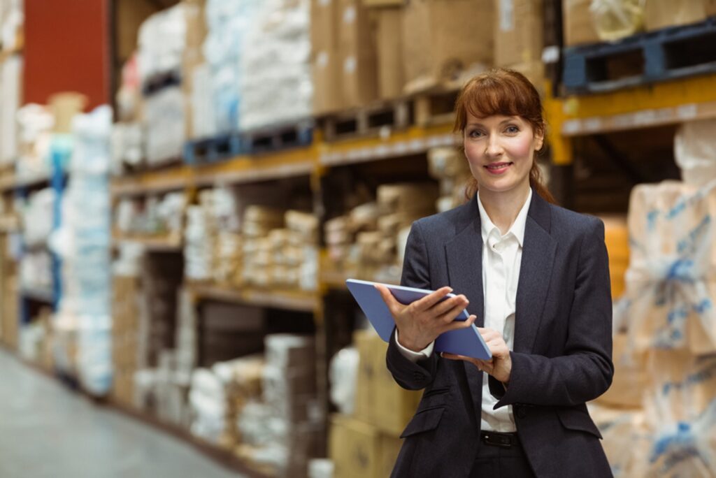 a woman holding a tablet in a warehouse