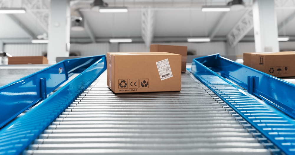 box moving down ramp on automated sorting conveyor system