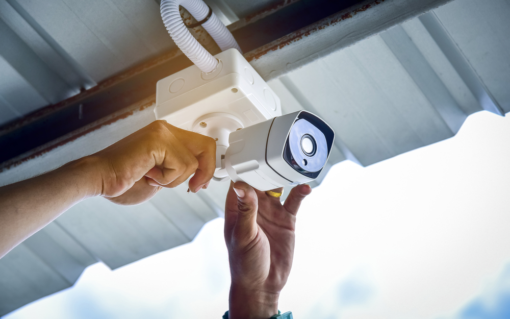 hands positioning warehouse security cameras