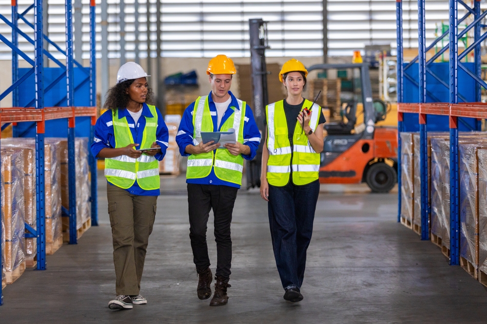 manager and workers conducting osha warehouse safety checklist inspection