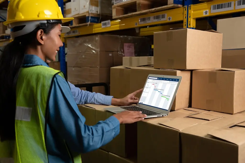 female warehouse worker using order fulfillment software