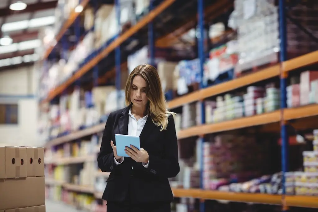 female warehouse professional using tablet